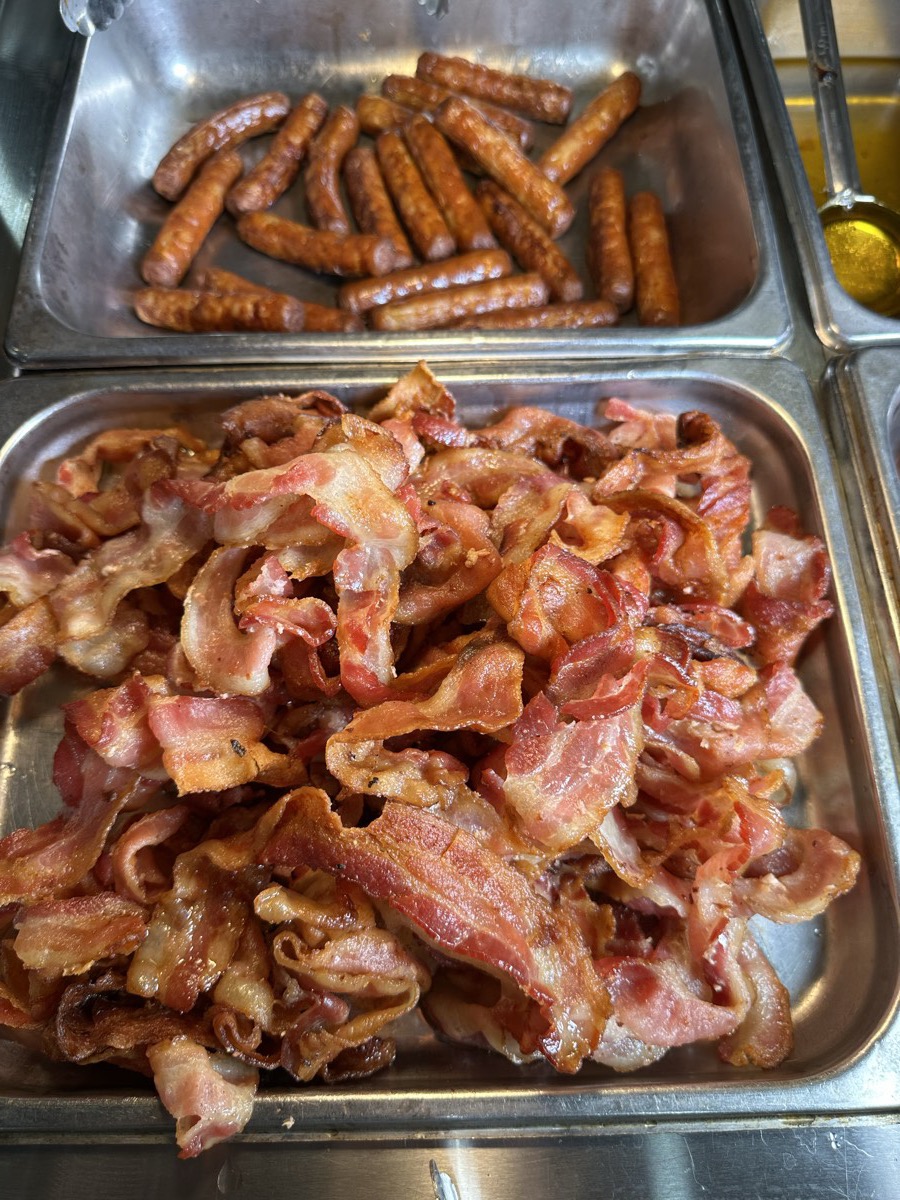 Bacon and sausage Serving trays of crisp bacon and breakfast sausages