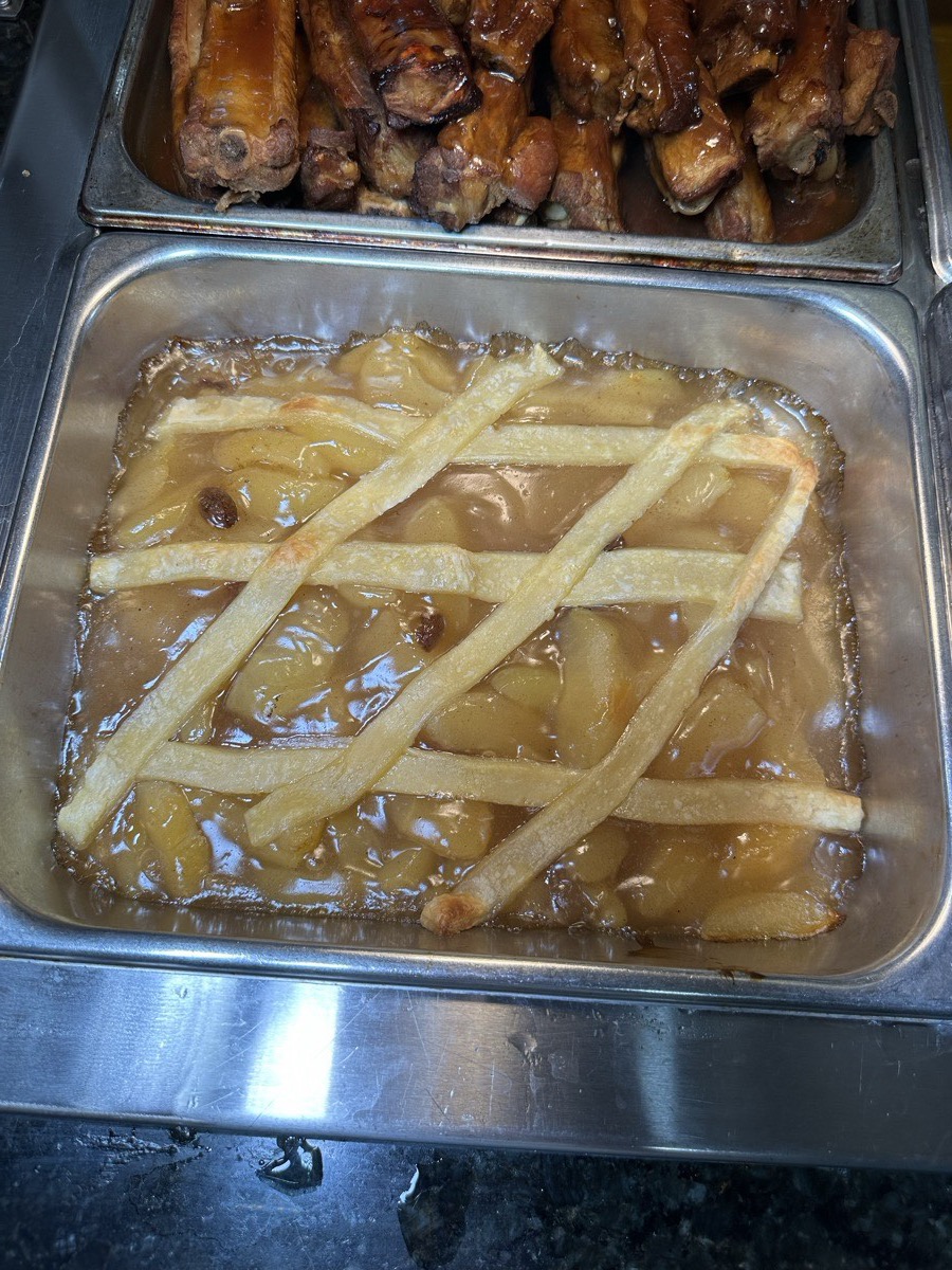 A baked casserole tray. A baked casserole topped with melted cheese