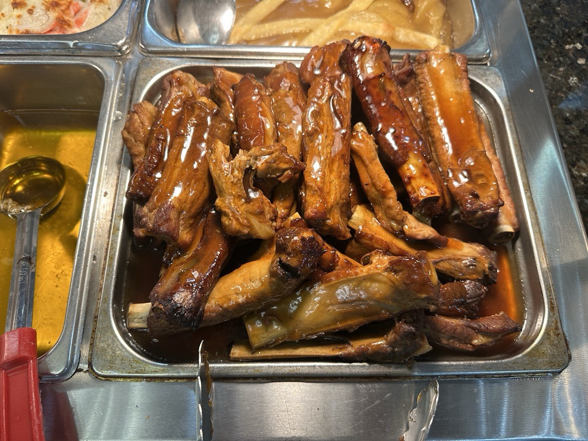 A tray of braised chicken drumsticks glazed in sauce