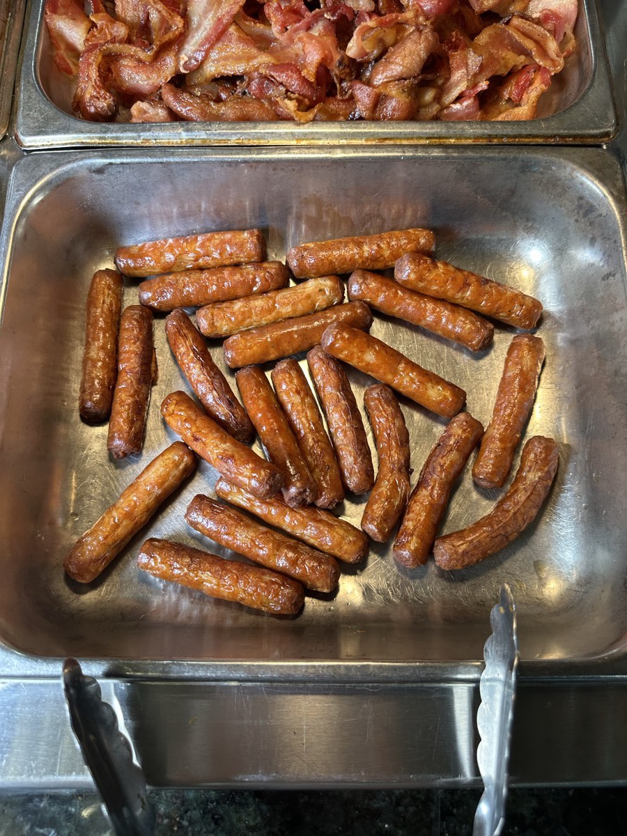 A serving tray of browned breakfast sausages