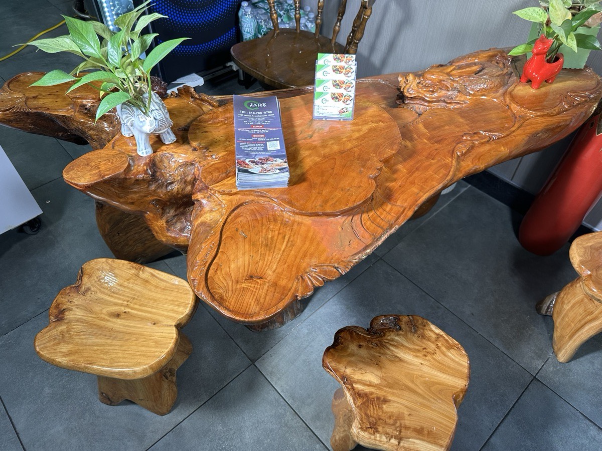 Carved wood table and stools A carved natural wood table and matching stools in the restaurant