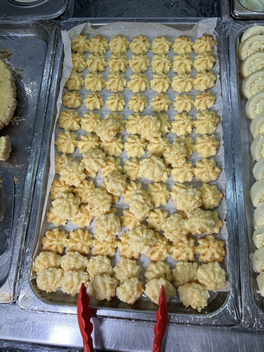 A tray of freshly piped coconut butter cookies