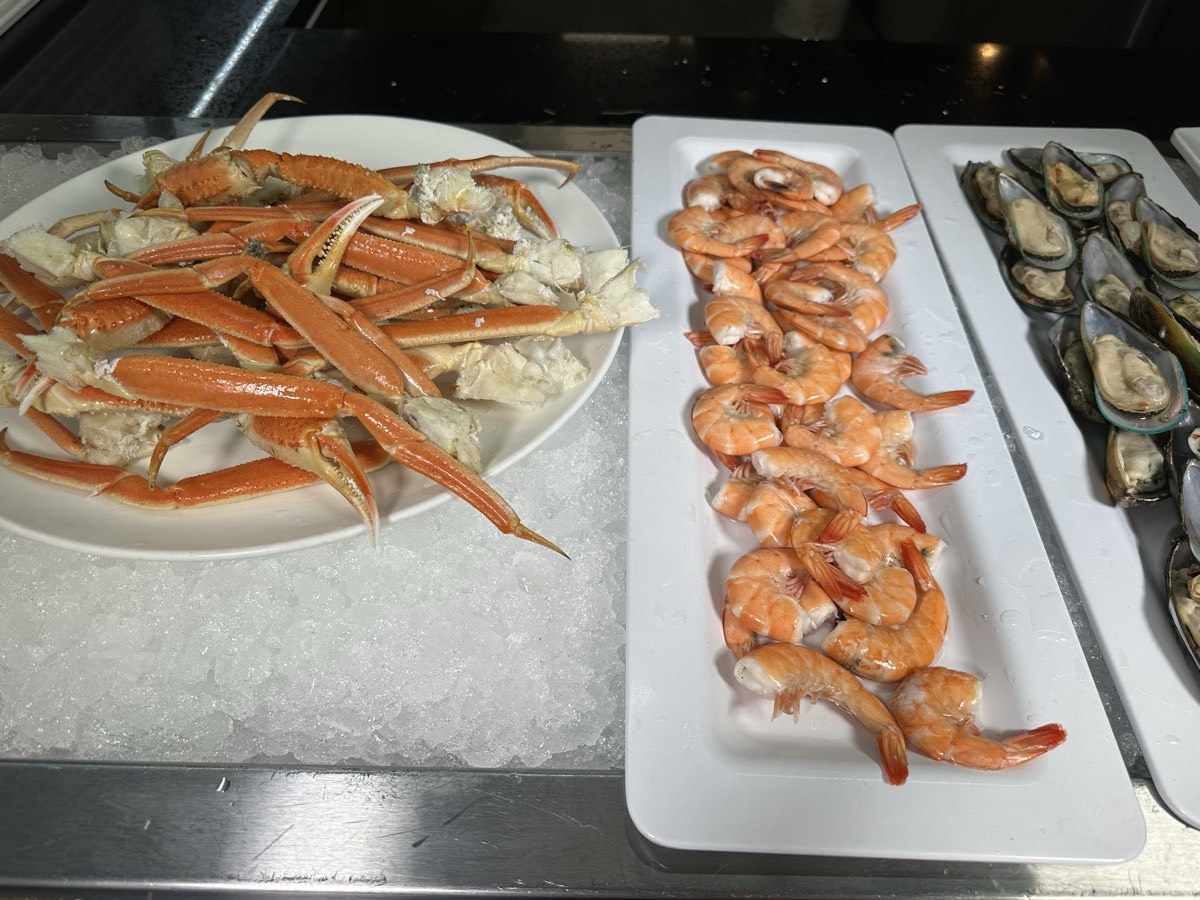 Crab legs, shrimp and oysters on ice. Snow crab legs, shrimp and oysters laid out together on ice