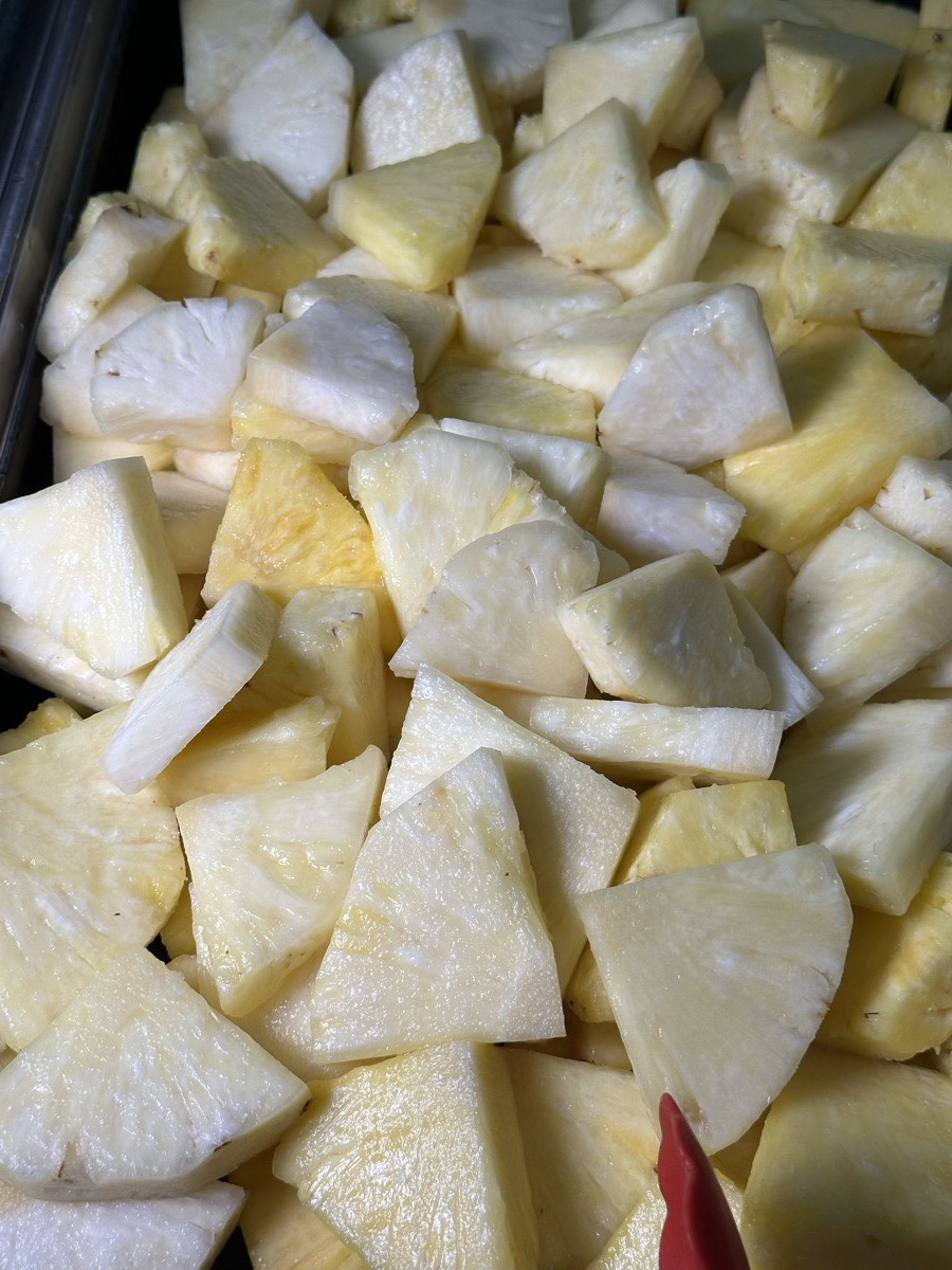 A tray of freshly cut honeydew and pineapple