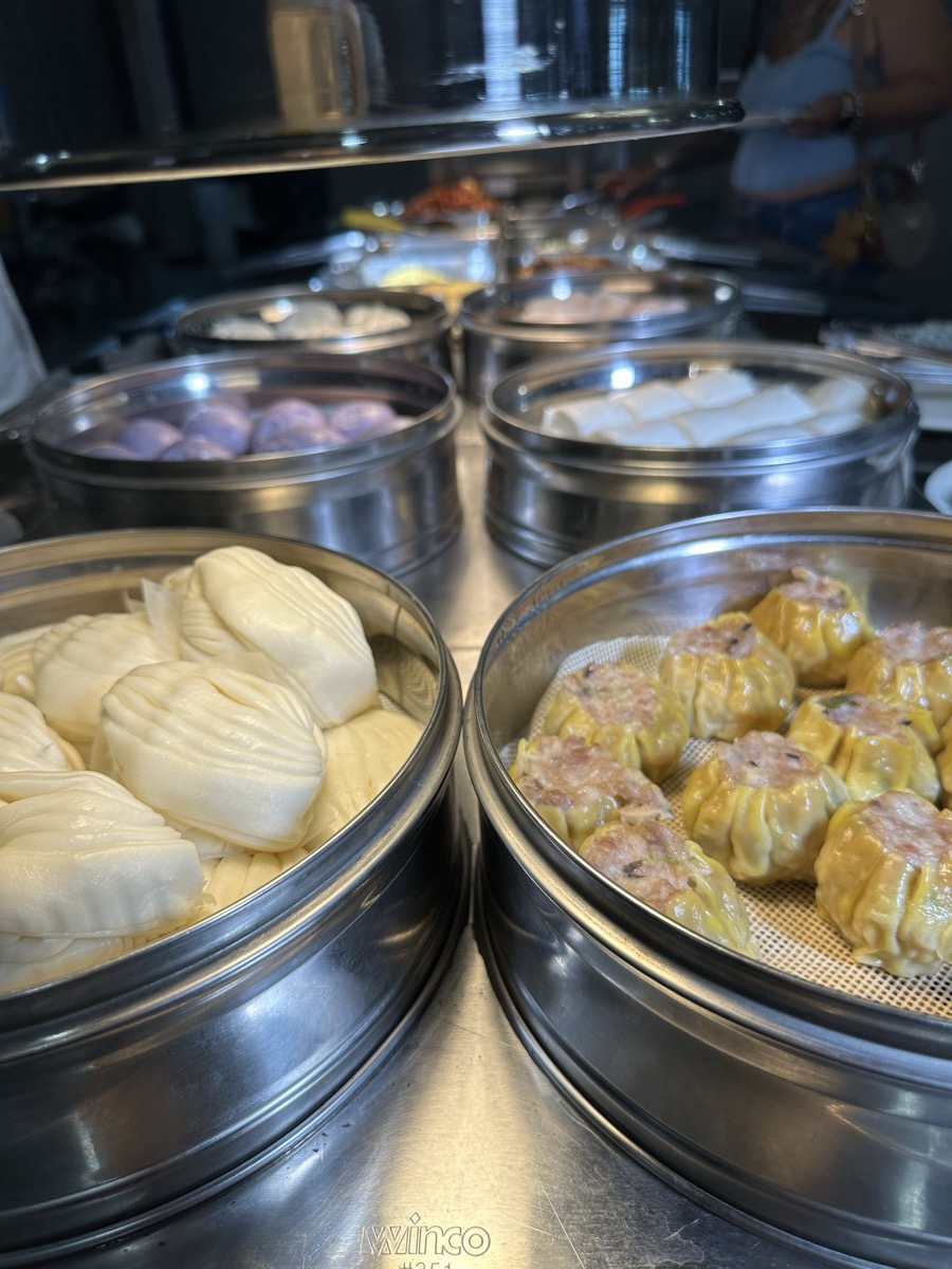 The dim sum steamers Stacked steamer baskets holding shumai, buns and taro buns on the dim sum counter