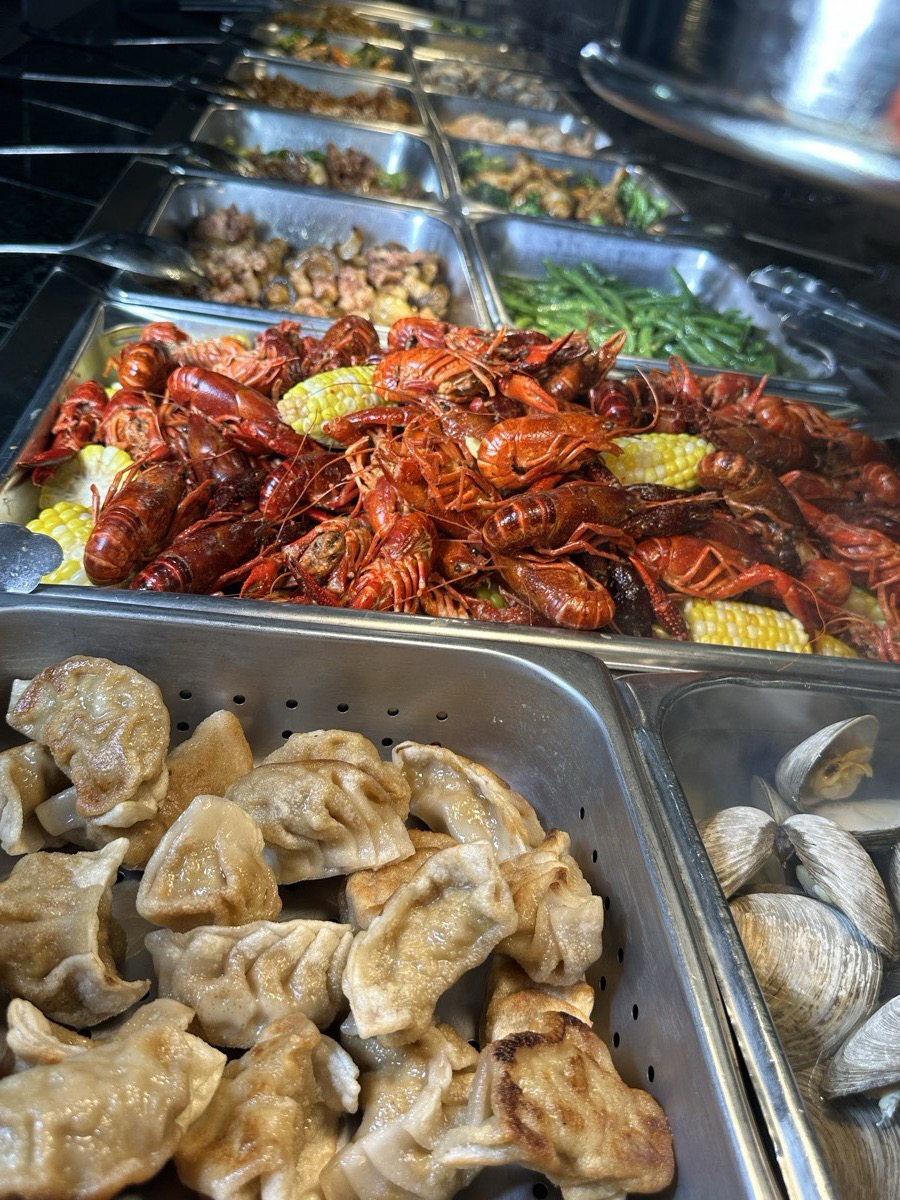 Dumplings beside the crawfish. A tray of steamed dumplings beside seasoned crawfish