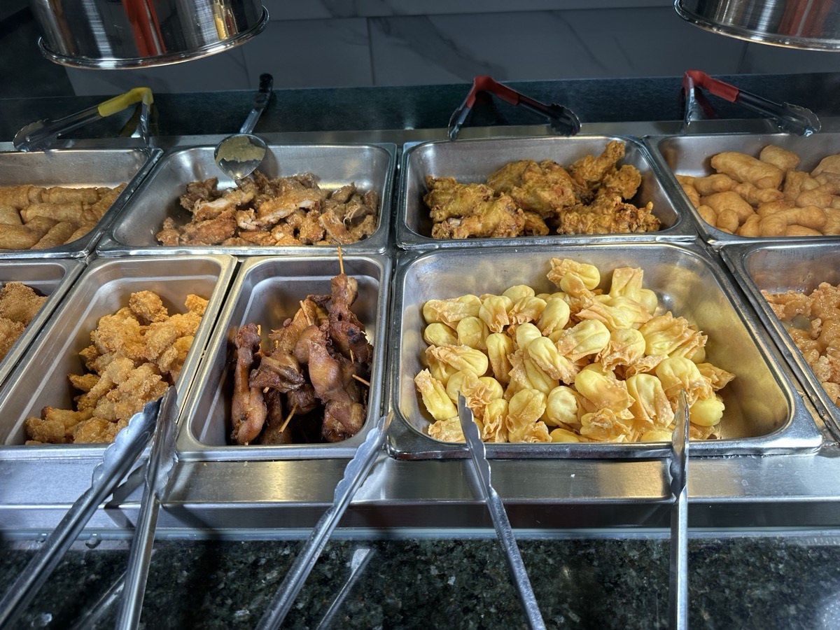 Serving bins of assorted fried appetizers on the hot line