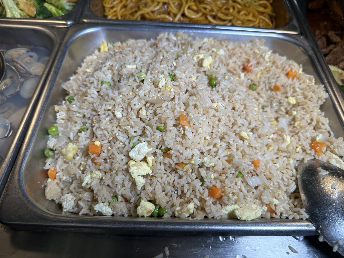 A large tray of fried rice with egg and vegetables