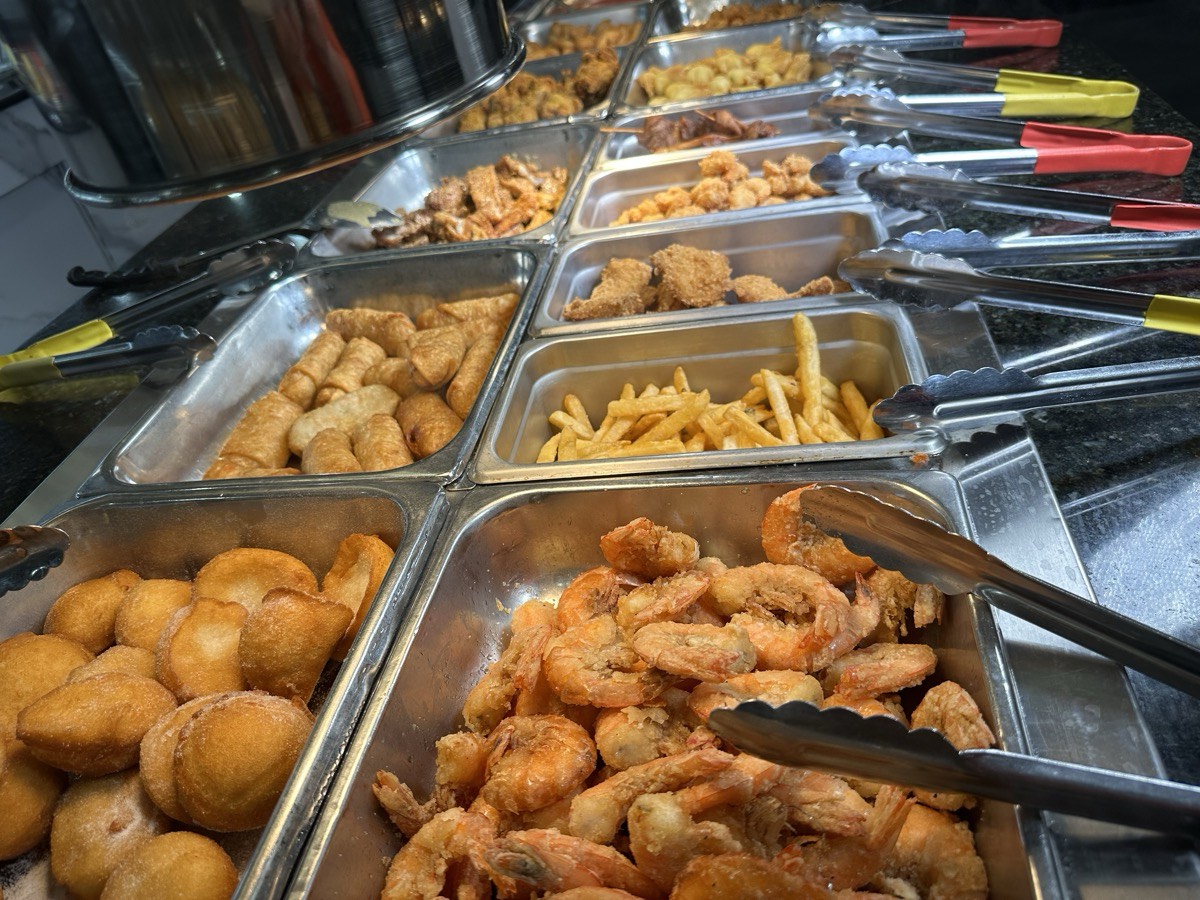 Trays of fried shrimp, french fries and fried nuggets