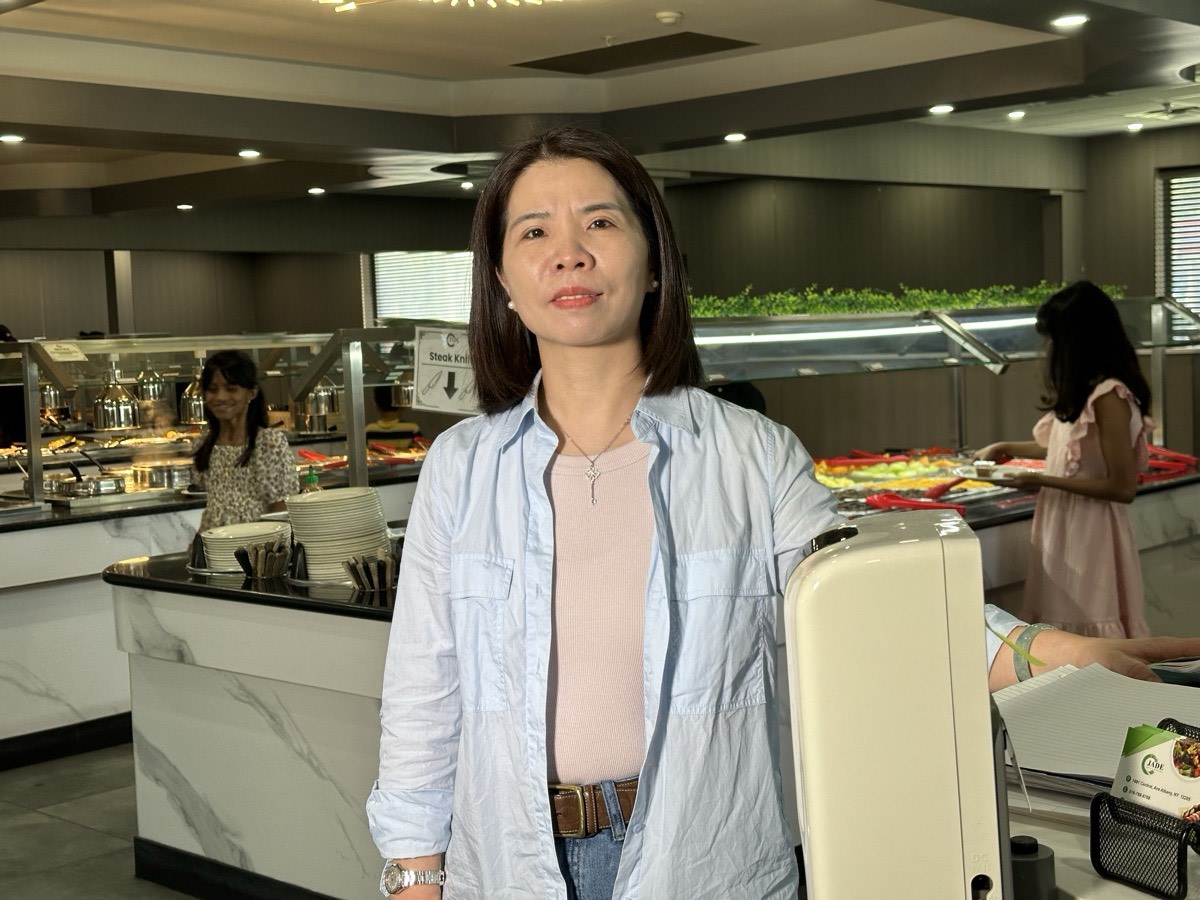 One of the owners of Jade Asian Buffet One of the owners of Jade Asian Buffet standing in the dining room while guests serve themselves at the buffet