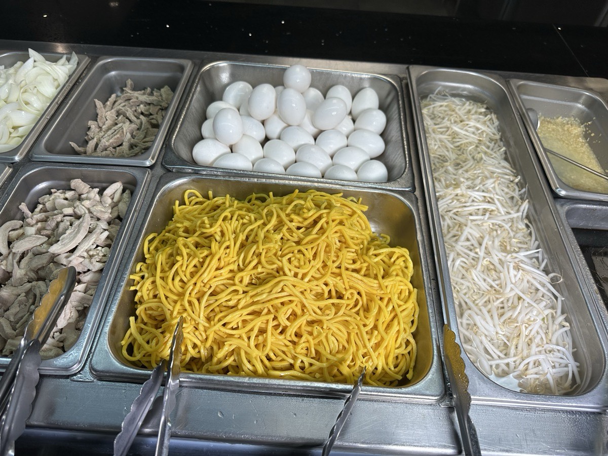 Noodles and toppings. Prep bins of noodles, eggs and bean sprouts