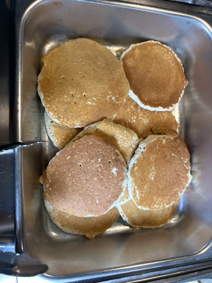 A serving tray of golden pancakes