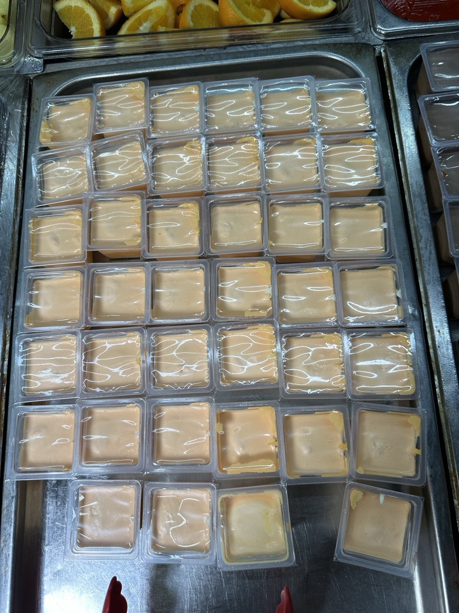 Rows of individual pudding cups set out on a tray