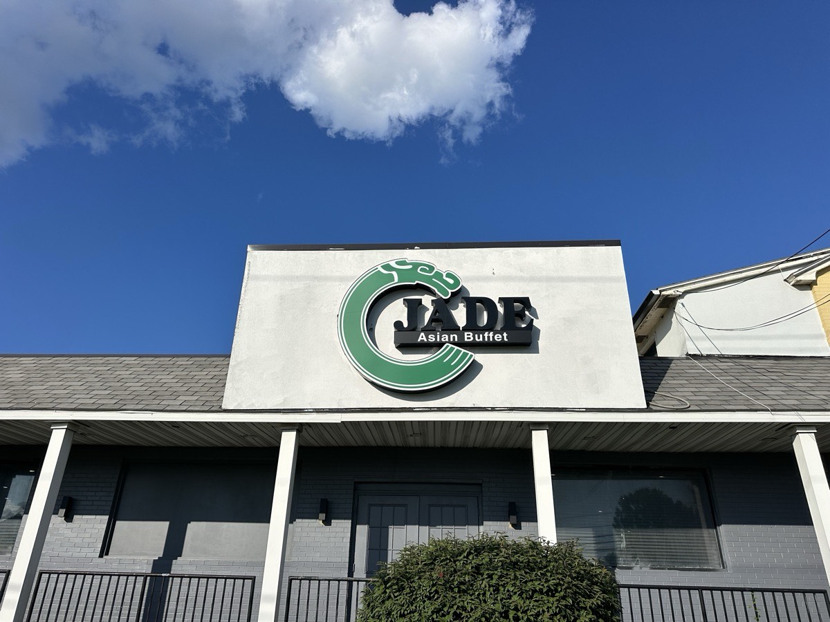 The Jade Asian Buffet sign The Jade Asian Buffet sign on the front of the building against a blue sky