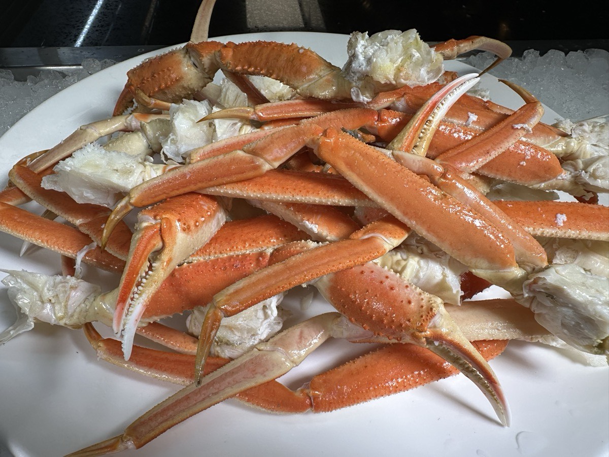 A platter piled with snow crab legs and crab meat