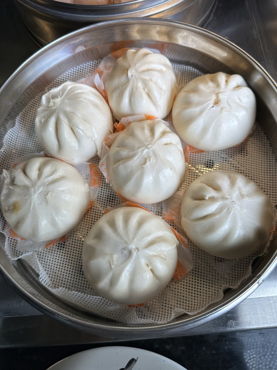 Steamed bao buns A steamer of pleated white steamed bao buns