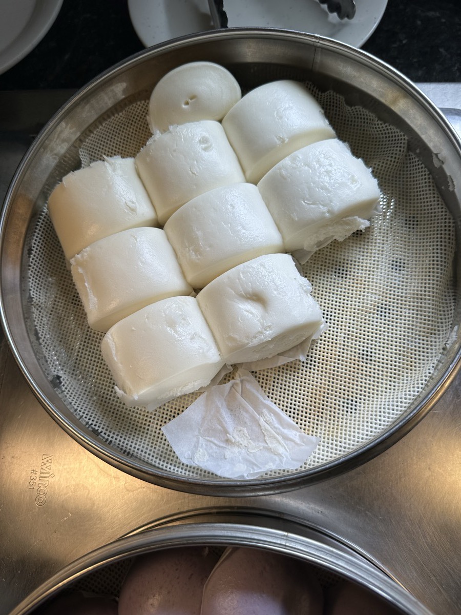 A steamer basket of soft white steamed buns